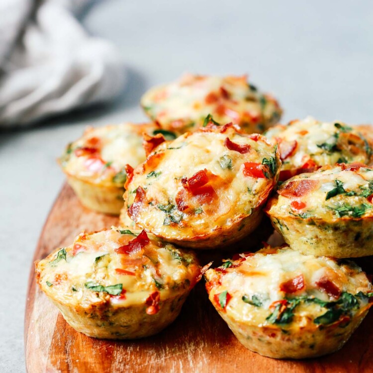 A close up of egg muffins on top of wooden serving board