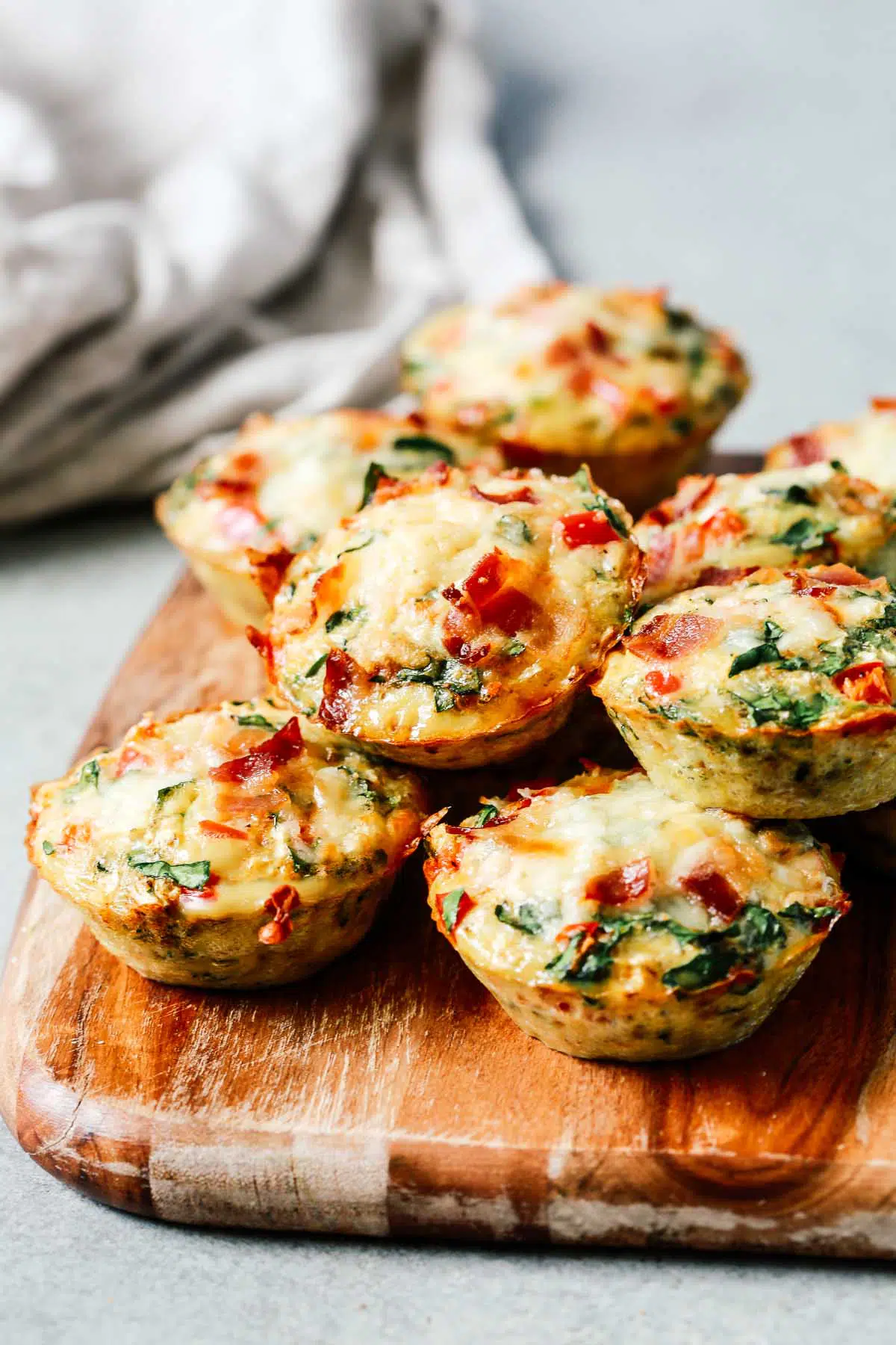 egg and vegetable muffins on wooden cutting board