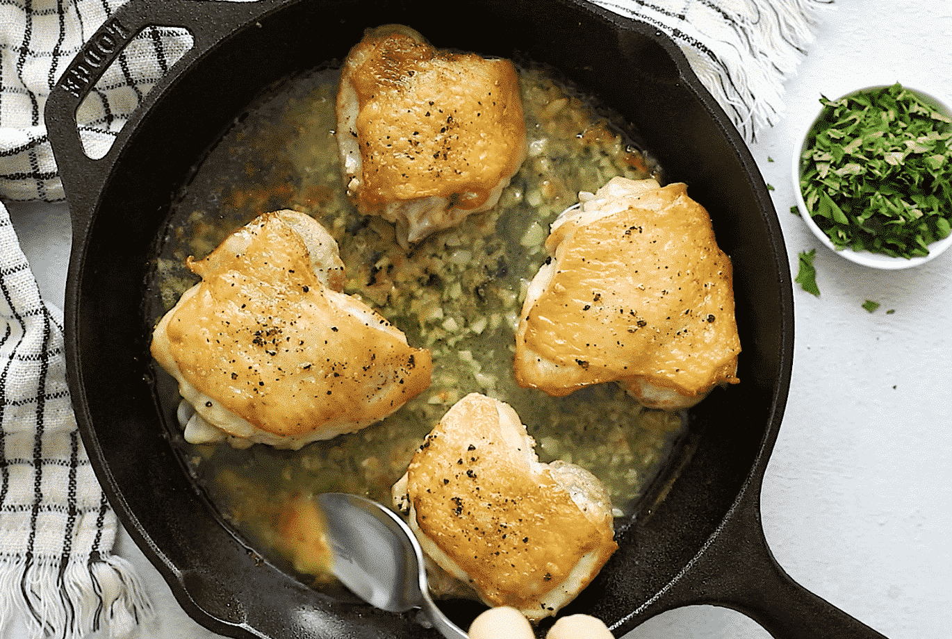 Chicken Thighs with crispy skin in a cast iron skillet 