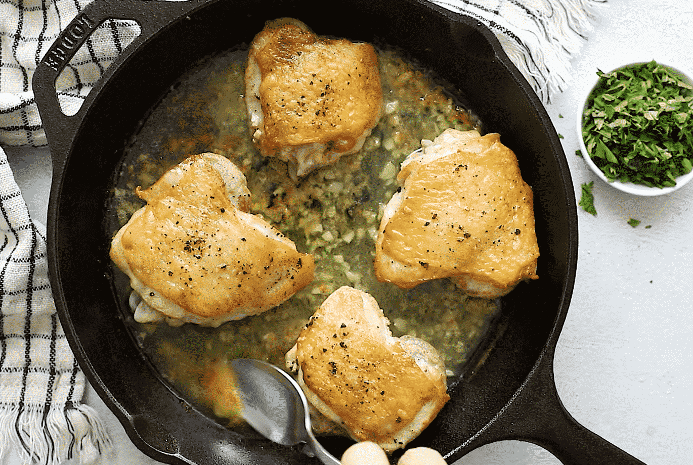 Chicken Thighs with crispy skin in a cast iron skillet