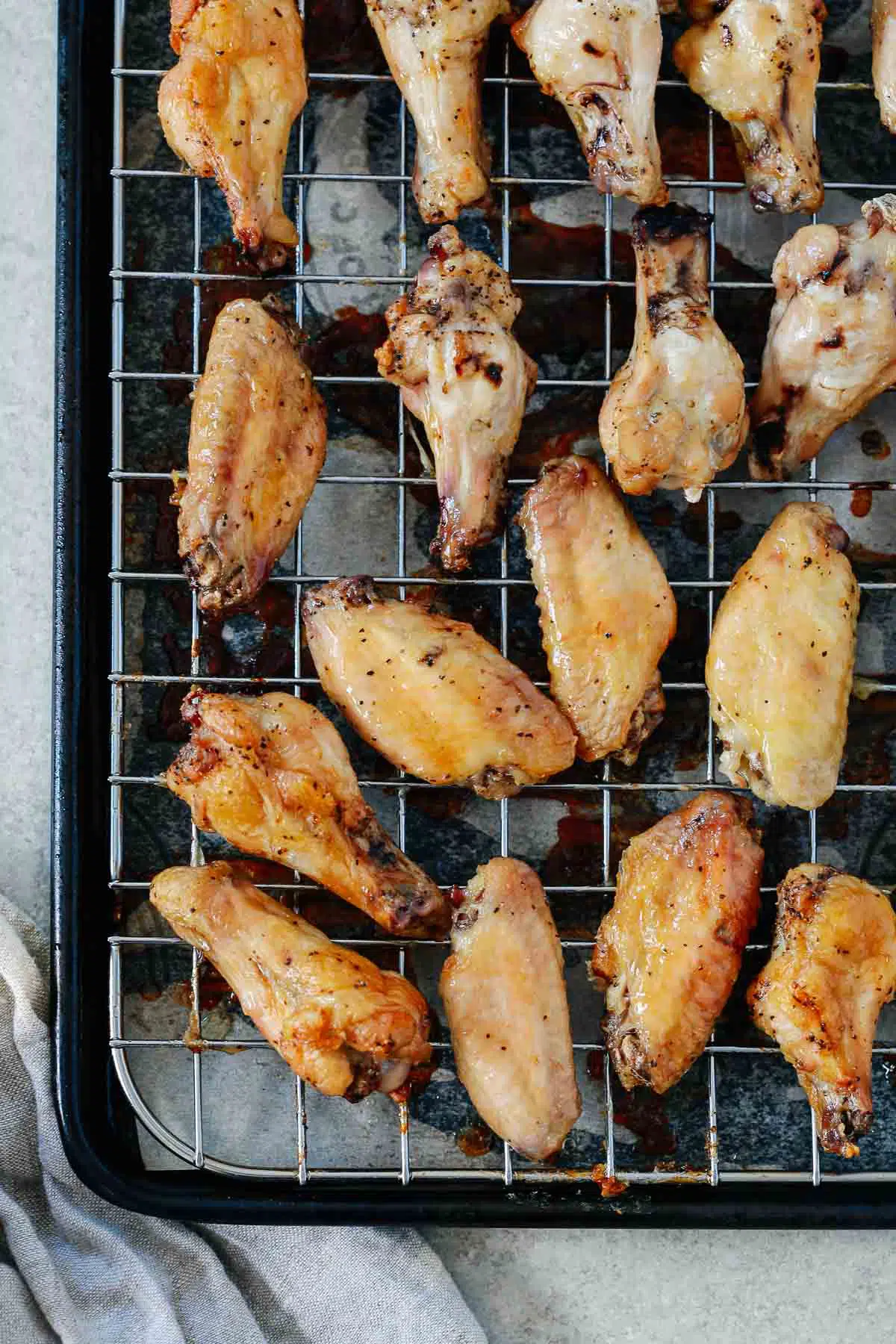 chicken wings cooked on top of a wired rack over a baking sheet