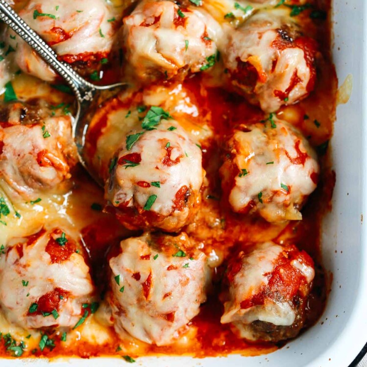 Close up of Baked Meatballs Casserole with a spoon lifting one meatball