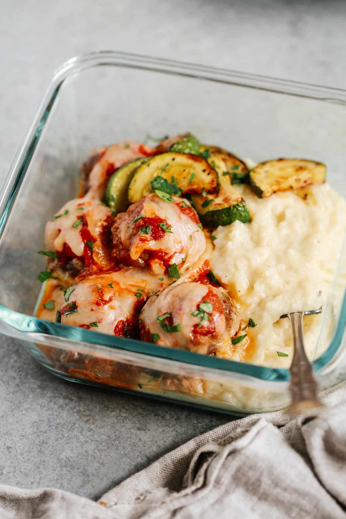 close up of the meatball casserole in a meal prep container 