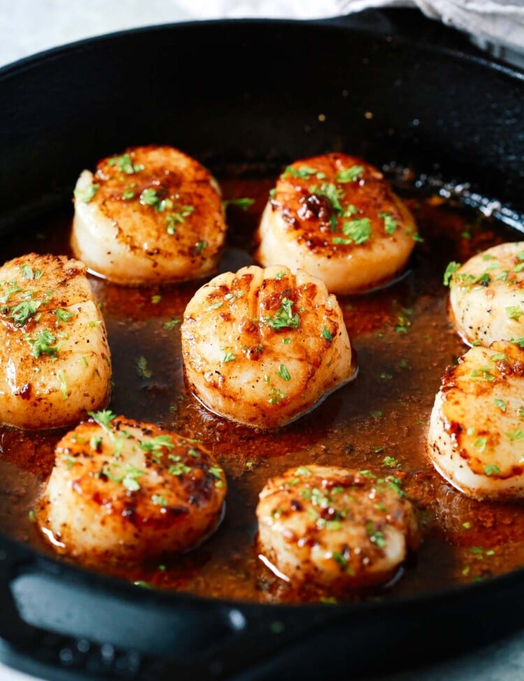 golden pan seared garlic butter scallops in a cast iron