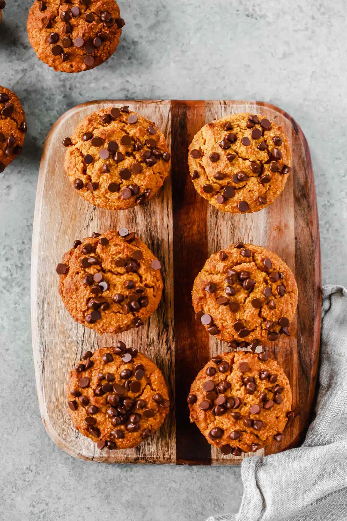 6 healthy pumpkin chocolate chip muffins on a serving board