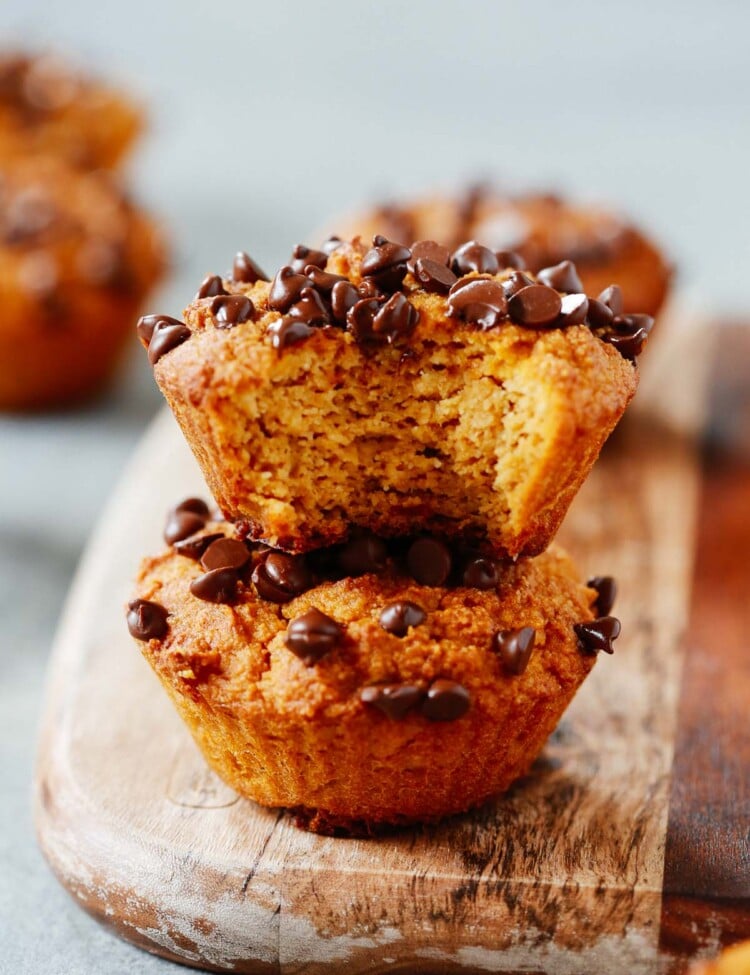 A close up of pumpkin chocolate chip muffins on a serving board