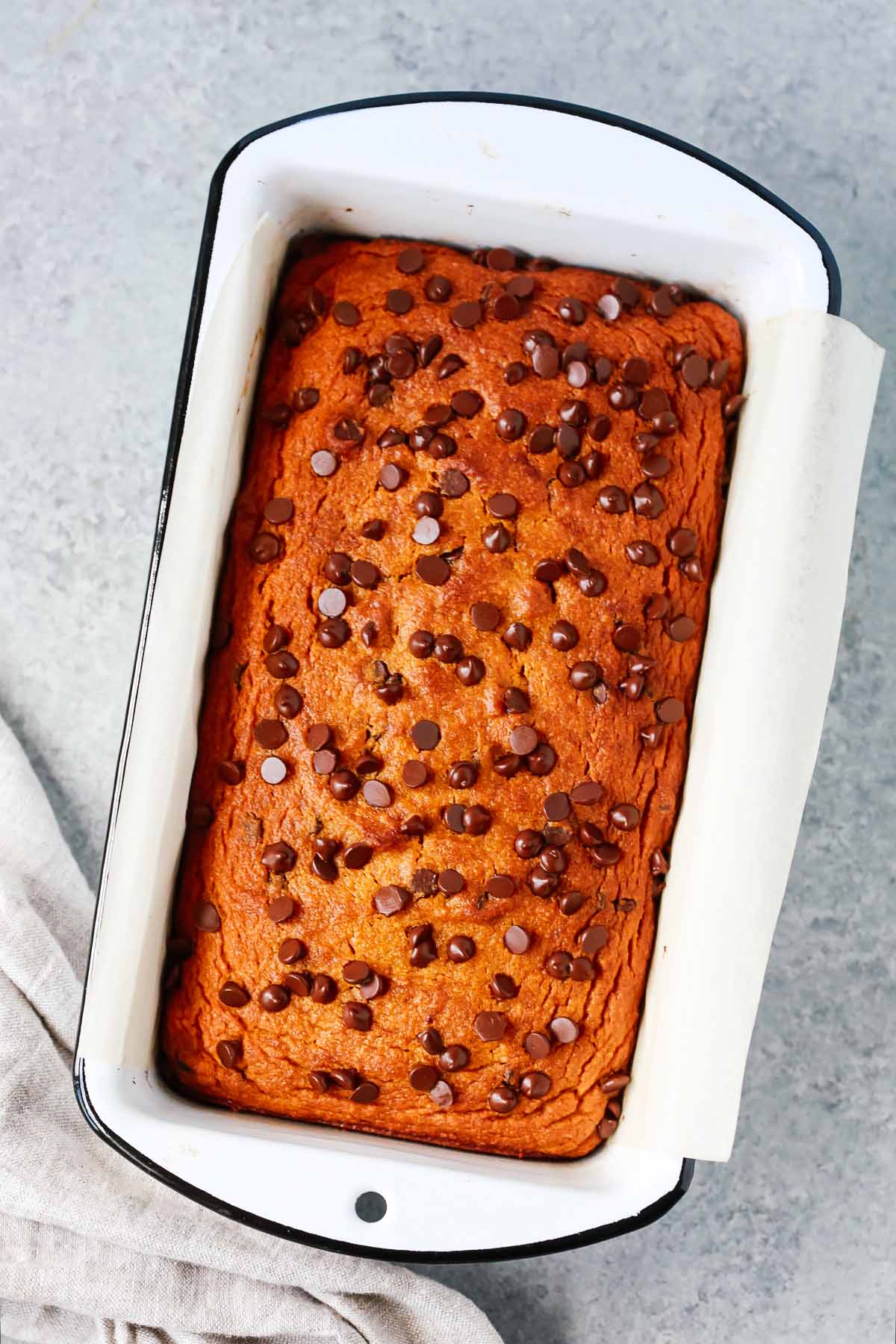 loaf pan with freshly baked healthy pumpkin chocolate chip bread