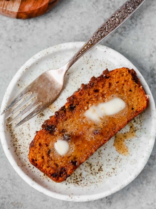 slice of healthy pumpkin chocolate chip bread on a white plate