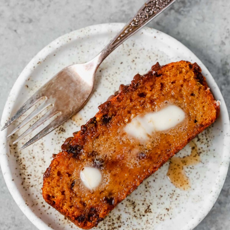 slice of healthy pumpkin chocolate chip bread on a white plate