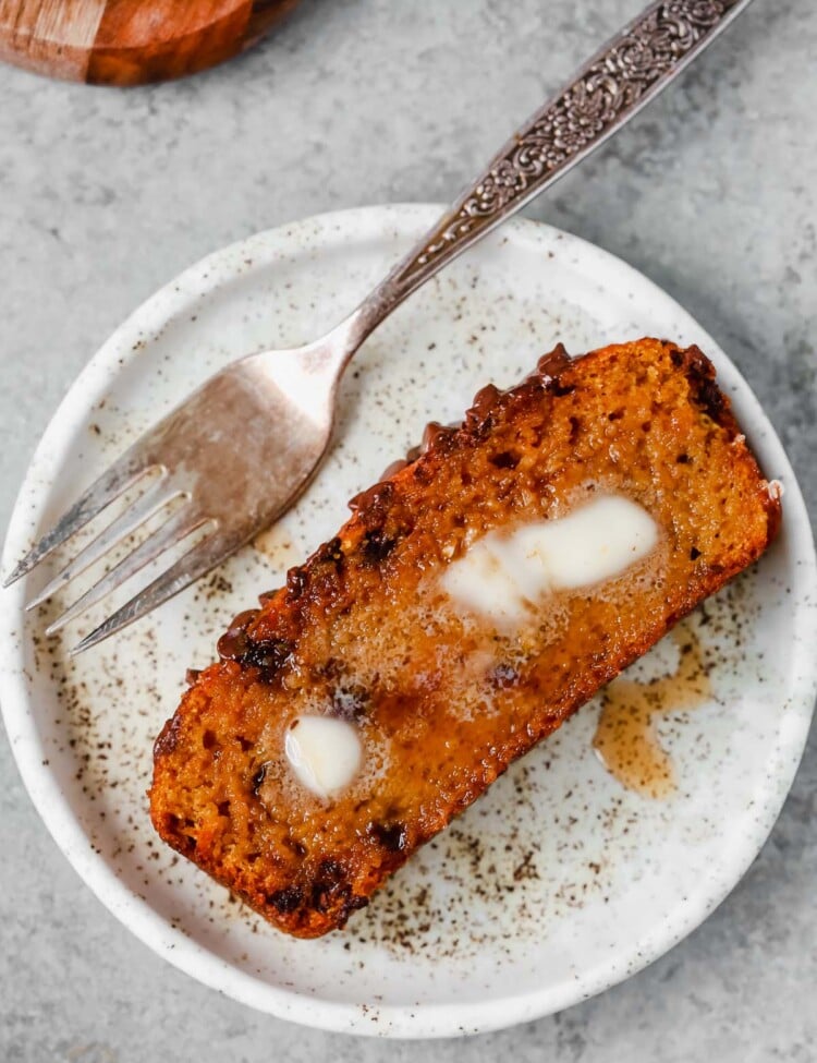 slice of healthy pumpkin chocolate chip bread on a white plate
