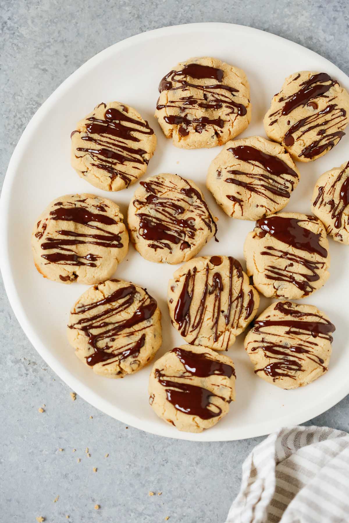 A white plate with multiple coconut flour chocolate chip cookies.