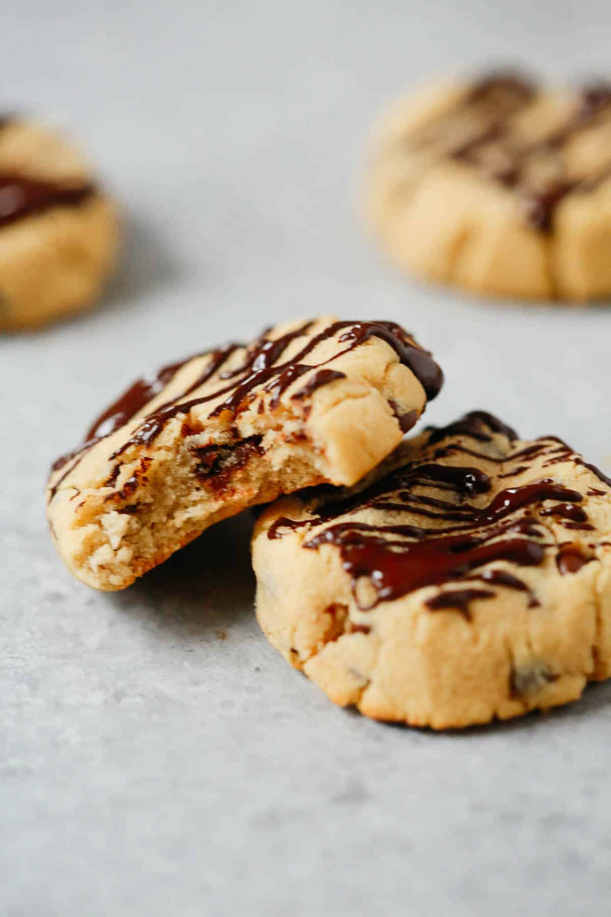 Two coconut flour chocolate chip cookies, one stacked on top of the other.