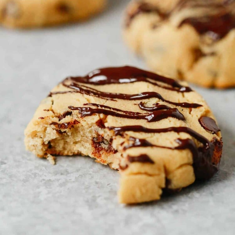 Close up of a coconut flour chocolate chip cookie with a bite taken out of it.