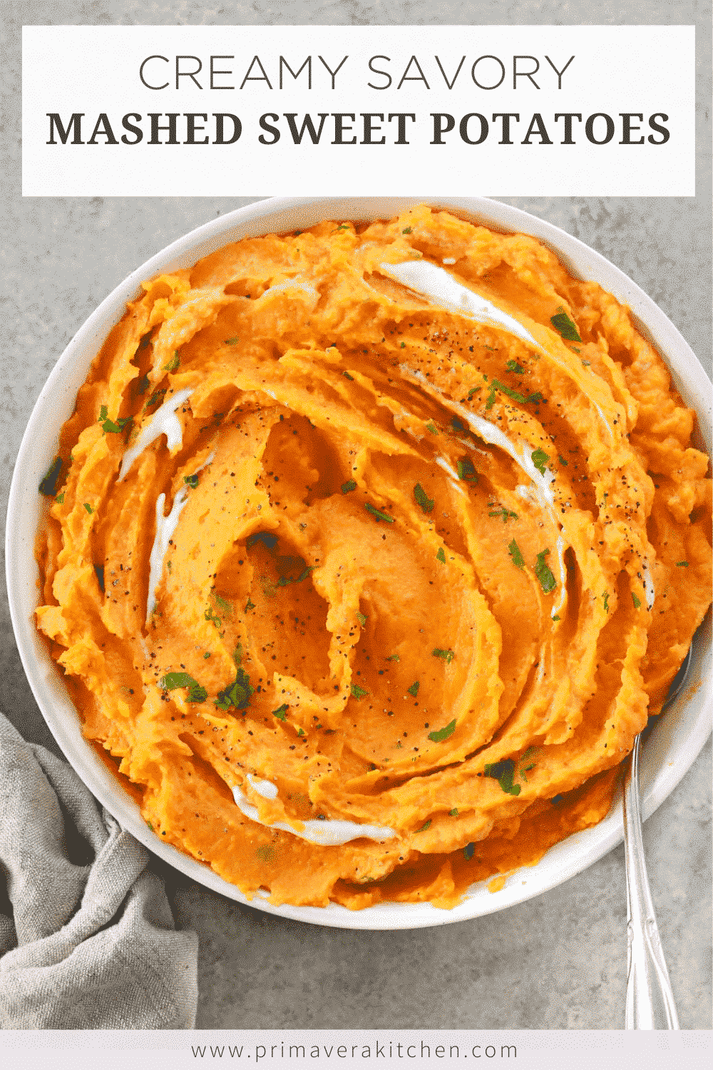 Overhead photo of a bowl of creamy savory mashed sweet potatoes with a spoon inside of it. 