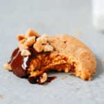 Close up of a cookie with a bite taken out of it.