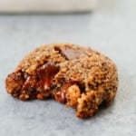 A photo of Chocolate Chunk Hazelnut Cookies with a bite taken out of it.
