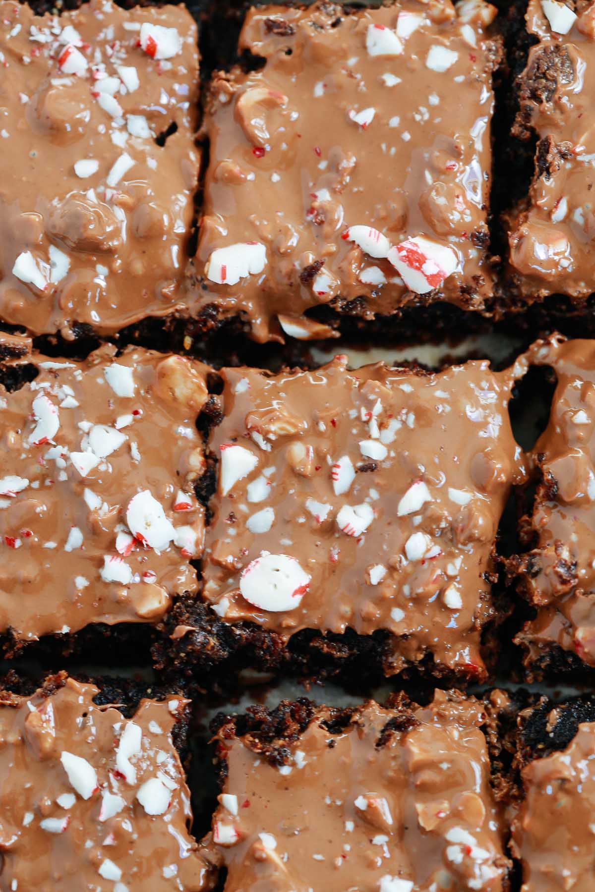 Overhead photo of cut gluten-free peppermint brownies with crushed candy canes on top. 