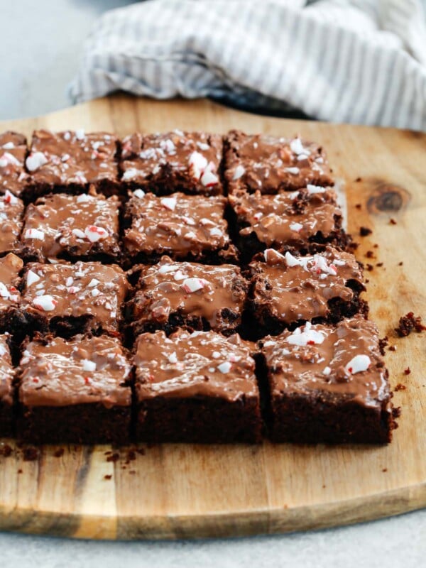 Angled photo of multiple gluten-free Peppermint Brownies cut on a serving board.