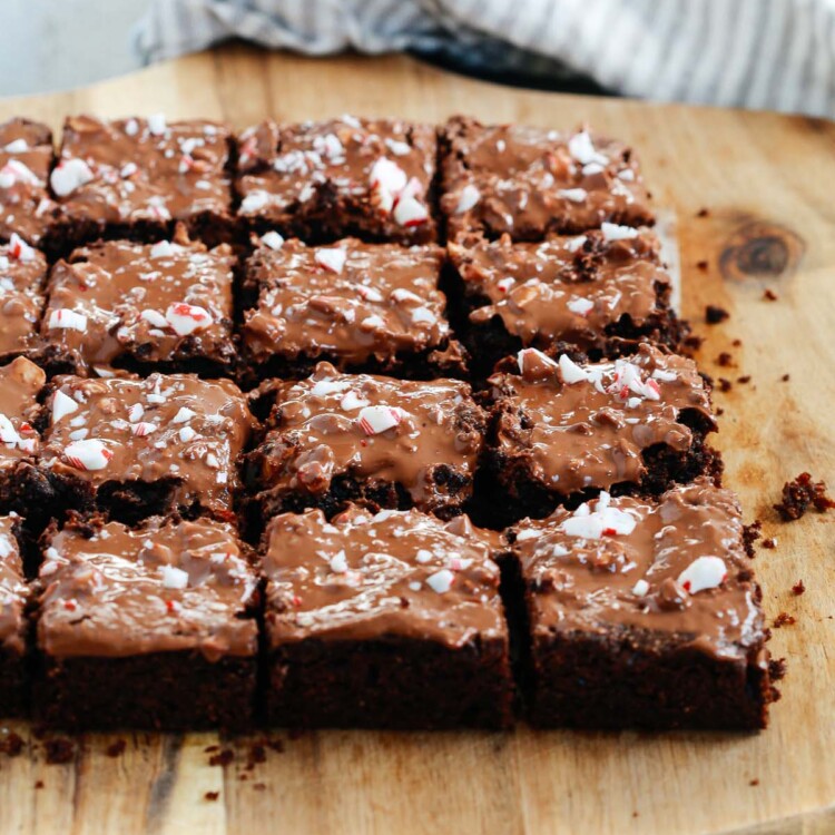 Angled photo of multiple gluten-free Peppermint Brownies cut on a serving board.