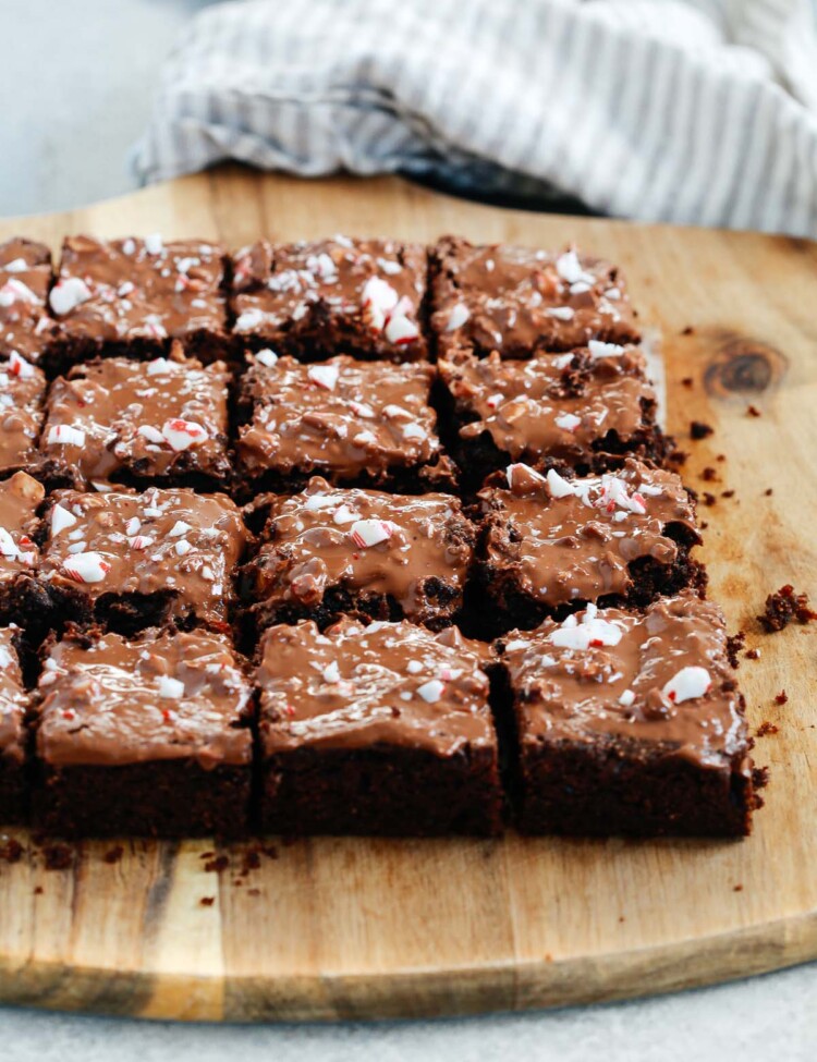 Angled photo of multiple gluten-free Peppermint Brownies cut on a serving board.