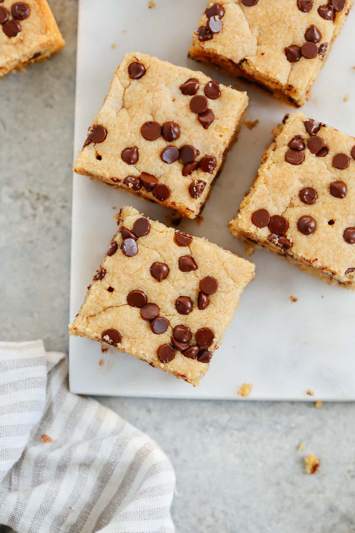 Overhead photo of four chocolate chip cookie bars cut into squares. 