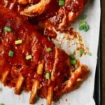 A close up of ribs on a baking sheet