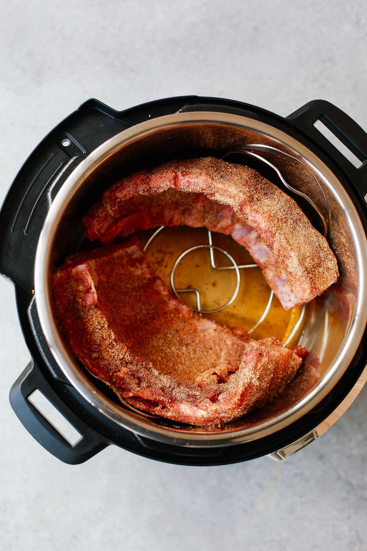 Set of two photos showing ribs inside of the Instant Pot before cooking