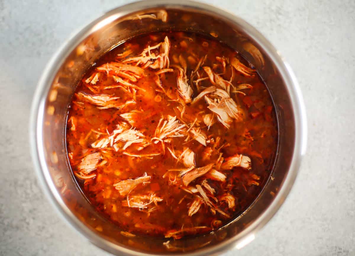 Instant Pot liner with soup and shredded chicken inside.