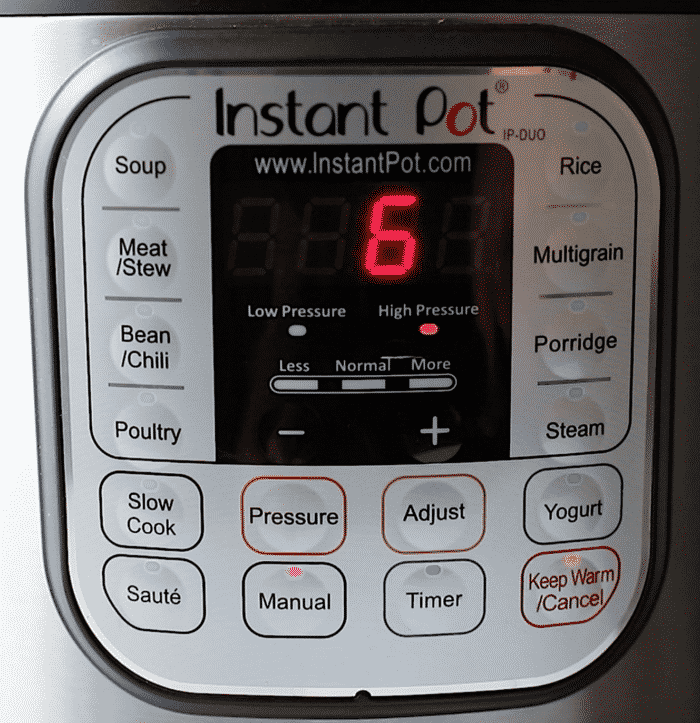 Close-up of an Instant Pot control panel with various buttons and a digital display showing the number 6 in red. Functions include Soup, Rice, Slow Cook, Pressure, Manual, Timer, and more.