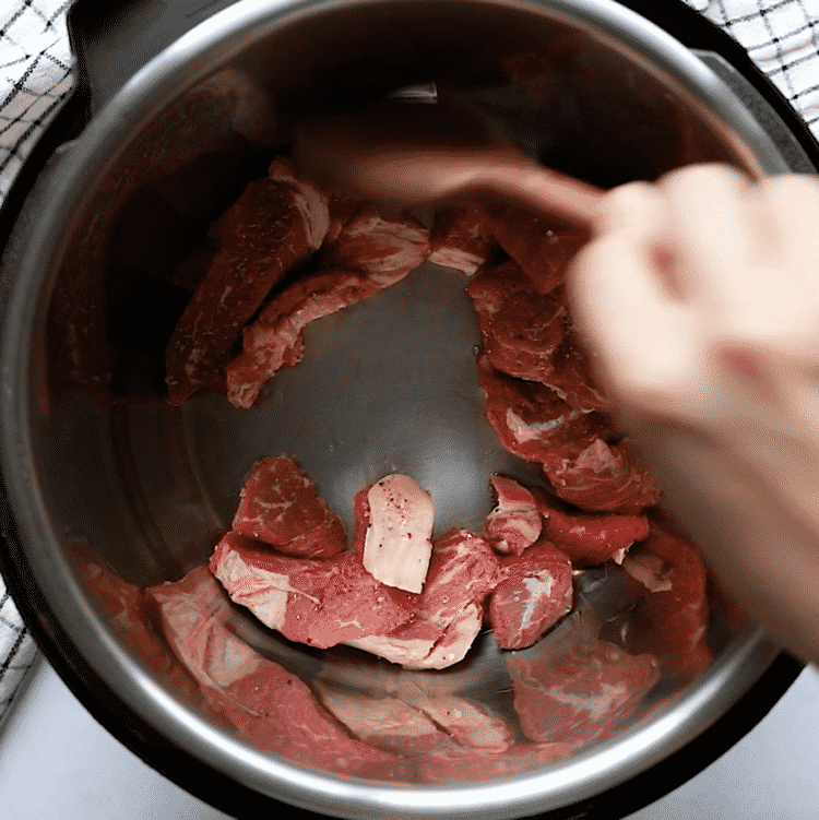 overhead view of instant pot containing sautéed sirloin steak