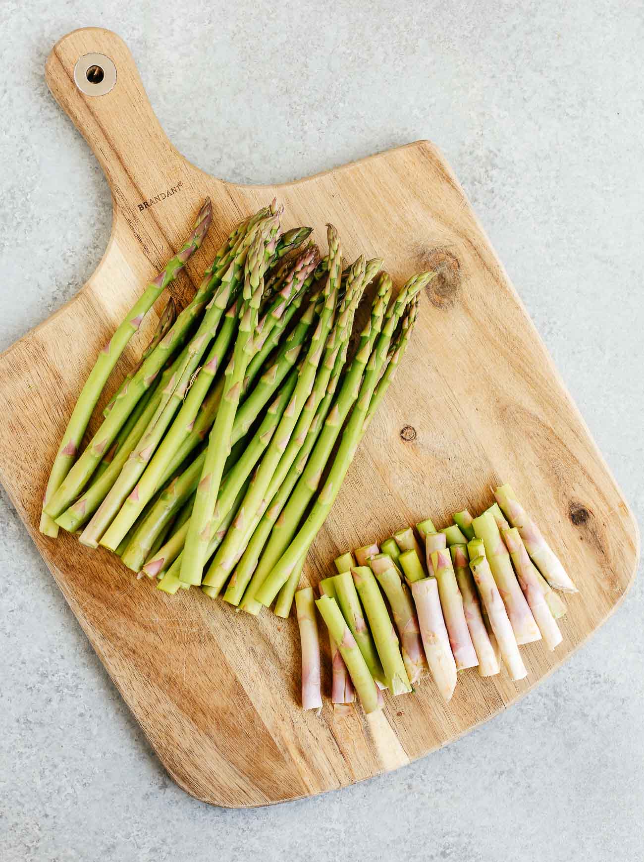 Cutting asparagus' tips off.