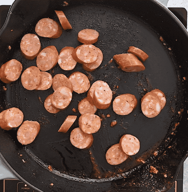 overhead view of a cast iron skillet containing sausage