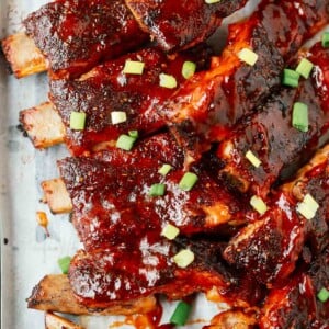 A close up of ribs on a wooden cutting board
