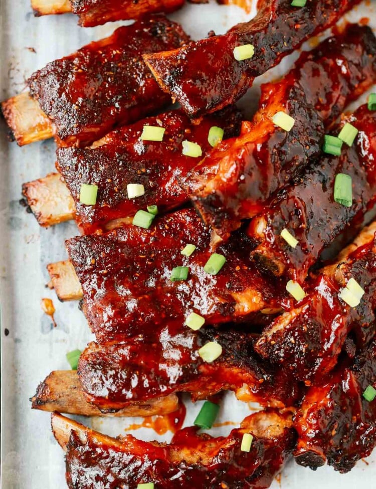 A close up of ribs on a wooden cutting board