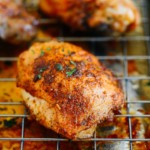 A close up of a chicken thighs on a rack