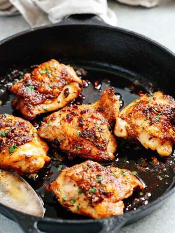close up of a white skillet containing Chicken Thighs