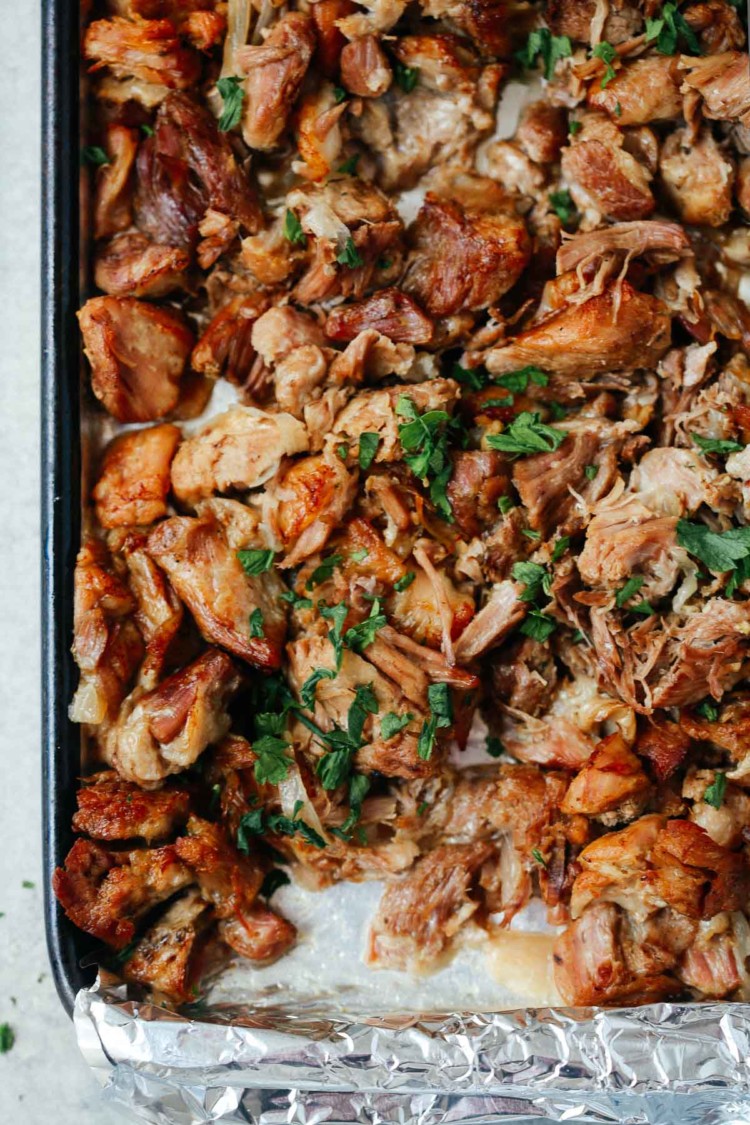 overhead view of carnitas on a baking sheet