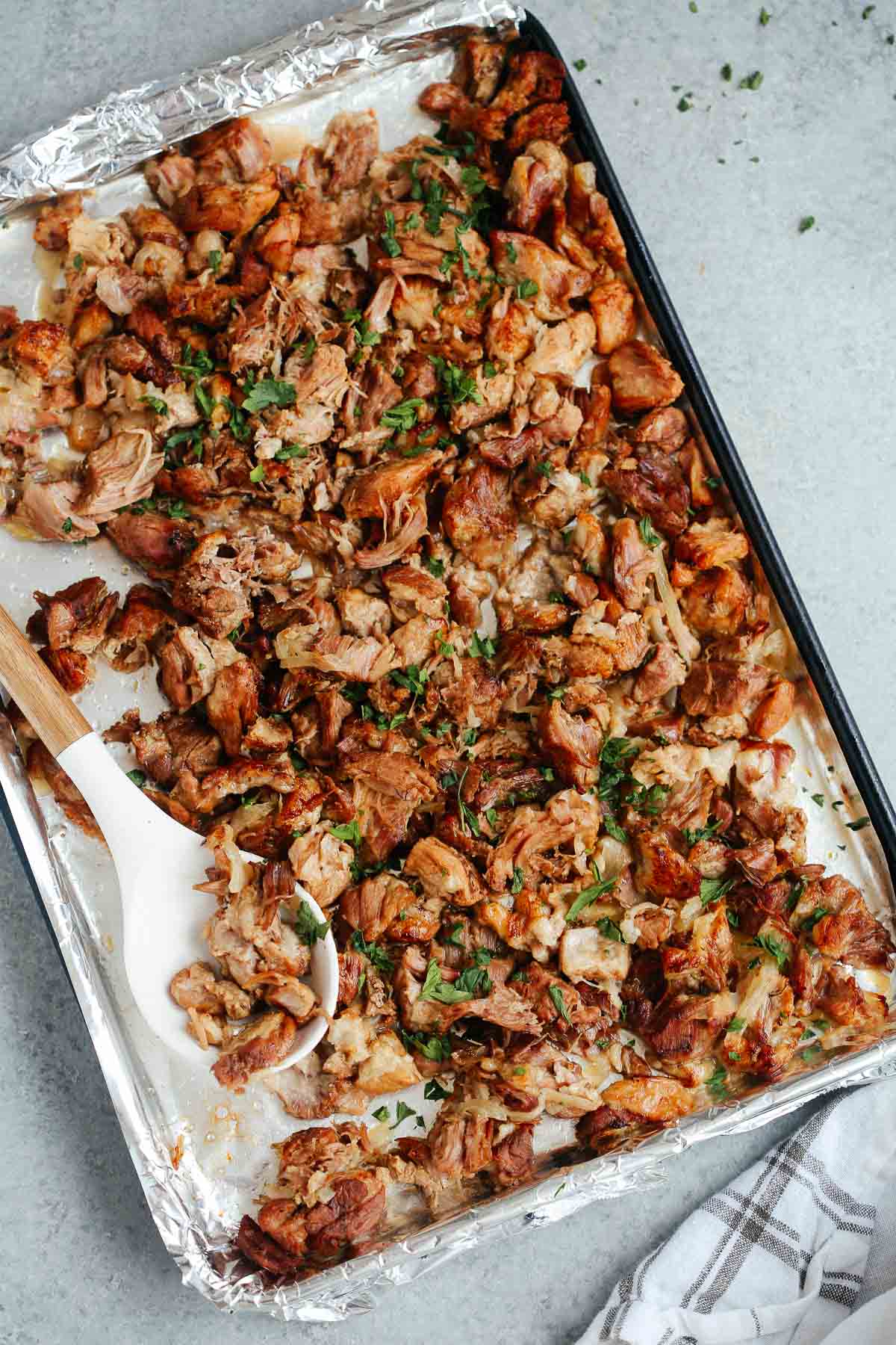 Instant Pot carnitas transfered to a sheet pan to broil in the oven.