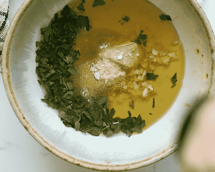 overhead view of a small bowl containing ingredients for dijon mustard salmon