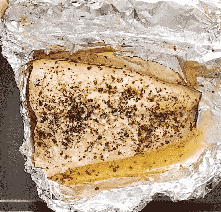 overhead view of cooked salmon in a foil
