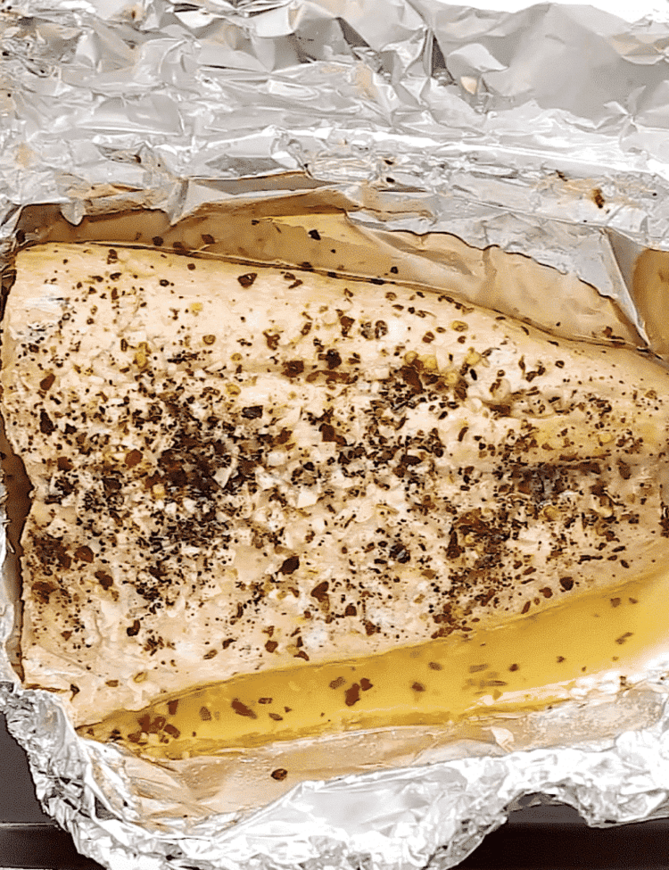 overhead view of cooked salmon in a foil