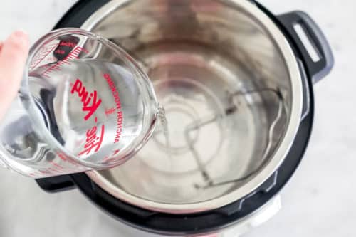 water being poured inside of an instant pot