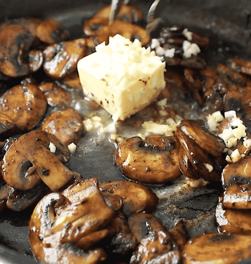 close up of sautéed mushroom with garlic and butter