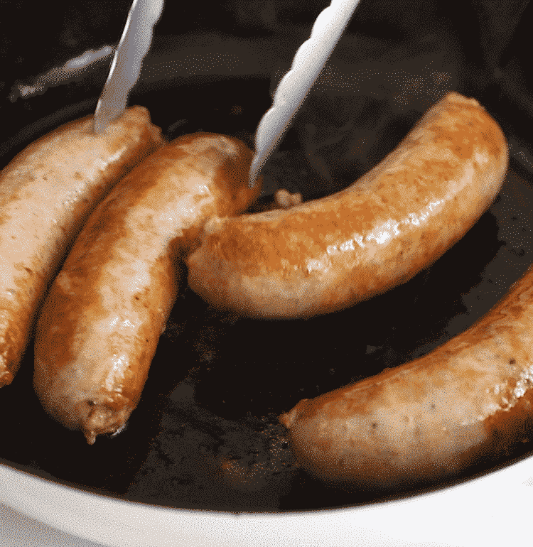 sautéed italian sausage in a cast iron skillet