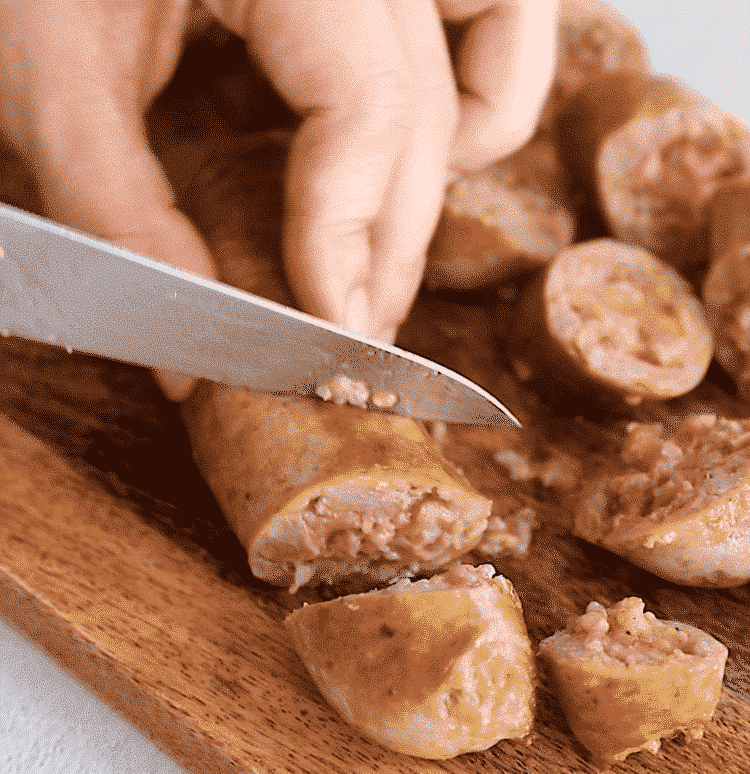 cutting sausage in a cutting board