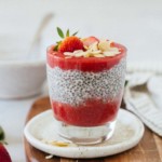 Strawberry chia seed pudding with strawberries and almonds on top.
