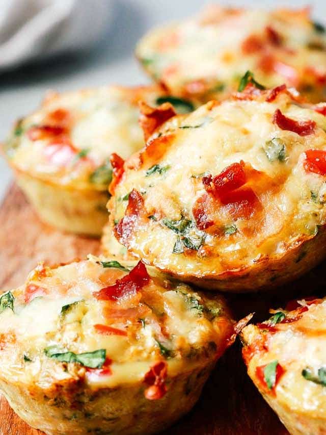 A close up of egg muffins on top of wooden serving board