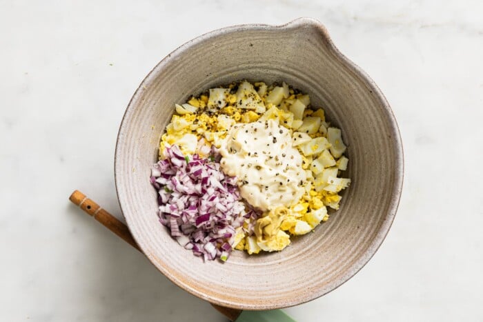 ingredients to make egg salad in a grey bowl