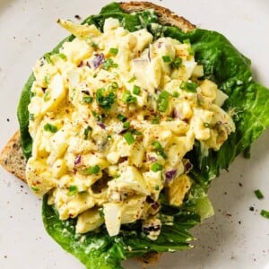 egg salad on top of some bread sliced.