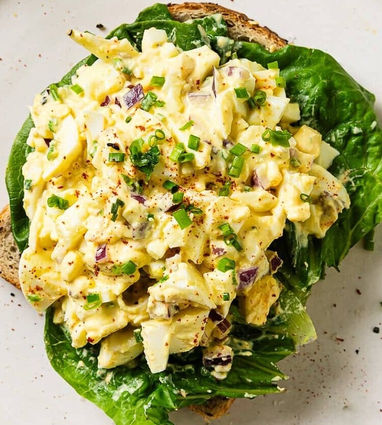 egg salad on top of some bread sliced.